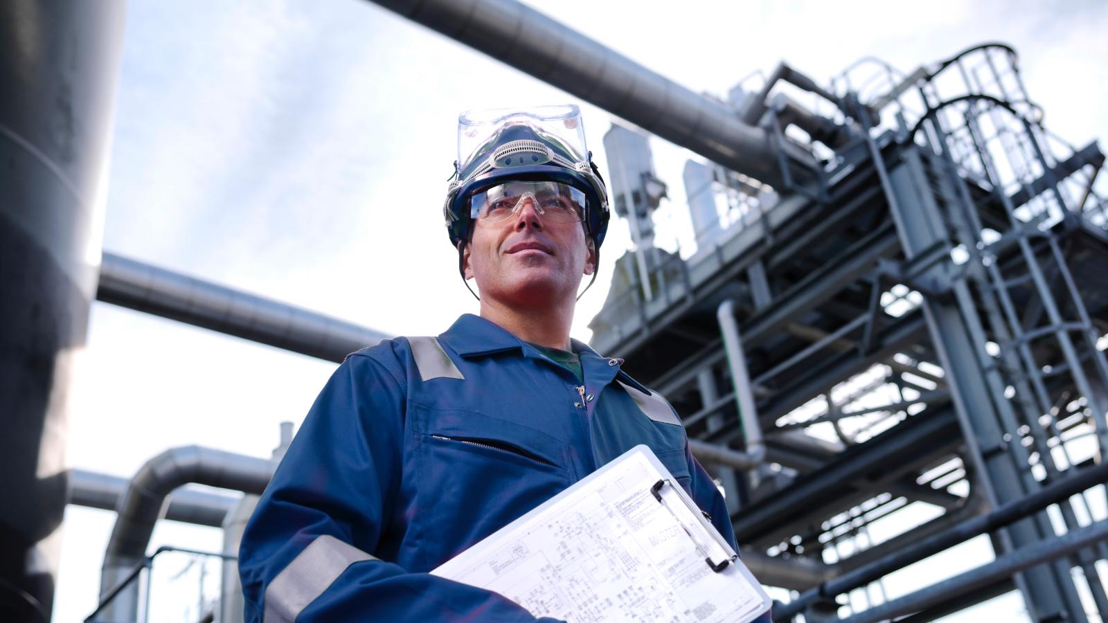 Worker in protective gear with clipboard